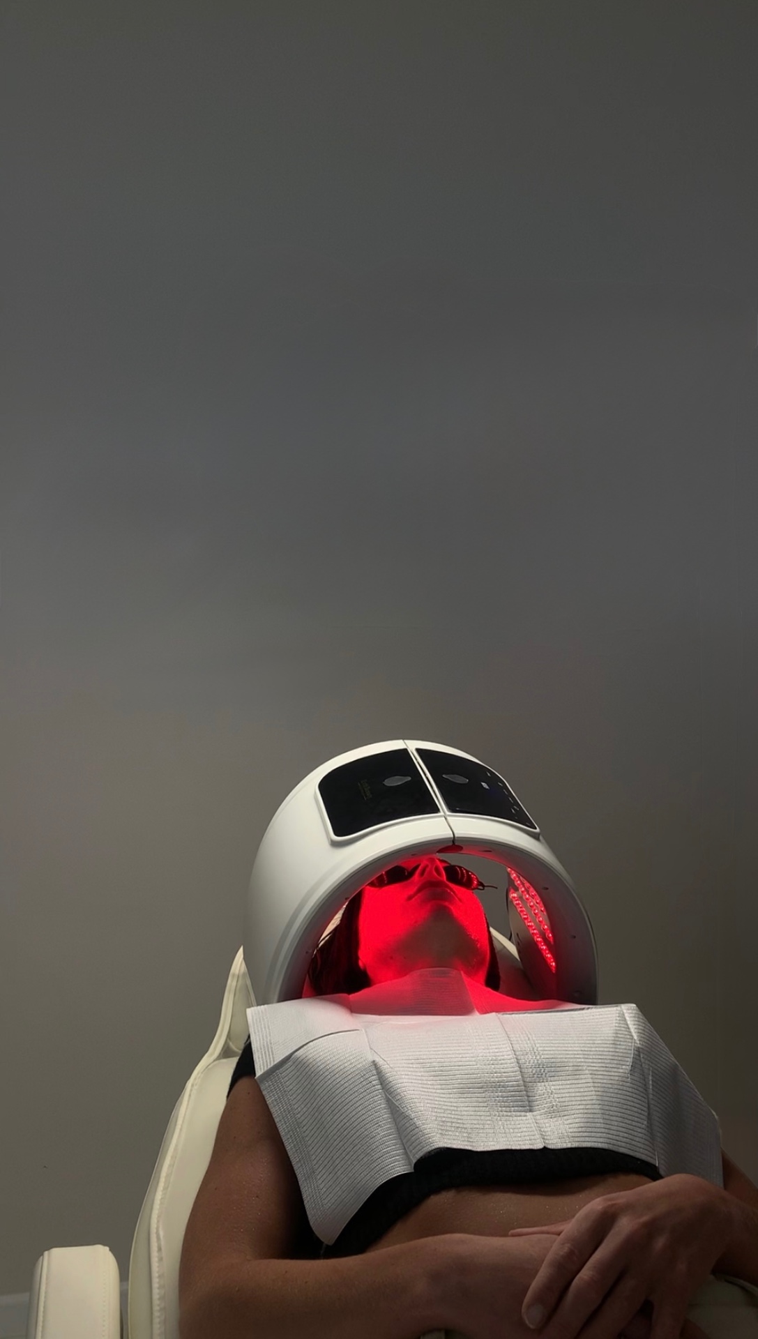 Red LED light therapy session on the skin at Glossed